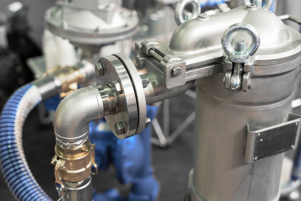 The metal pipeline with big flanges. It is painted by gray paint.